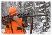 Hunter taking aim in snow