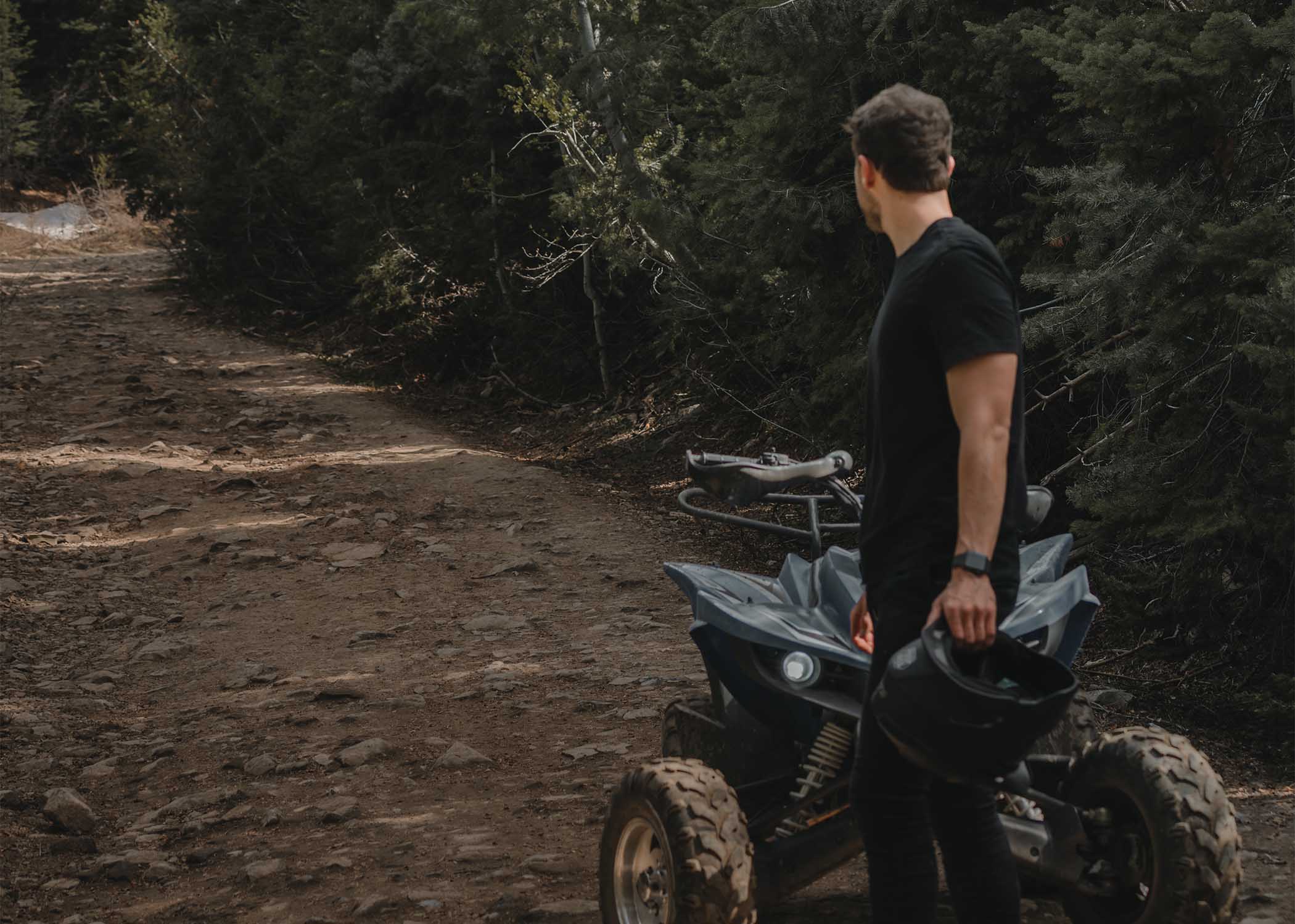 ATV rider looking back on a dirt road