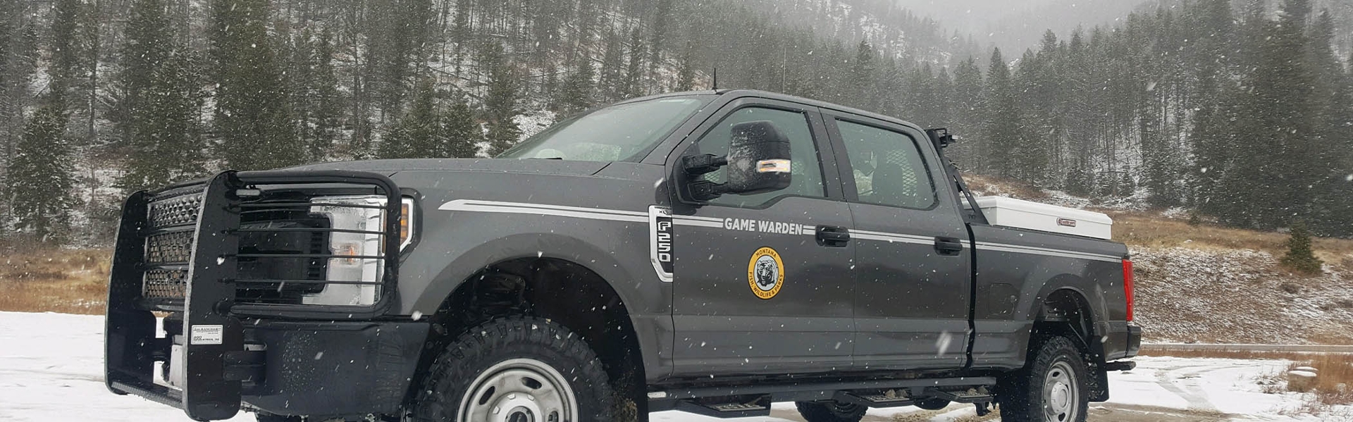 FWP Game Warden truck on a snowy hillside