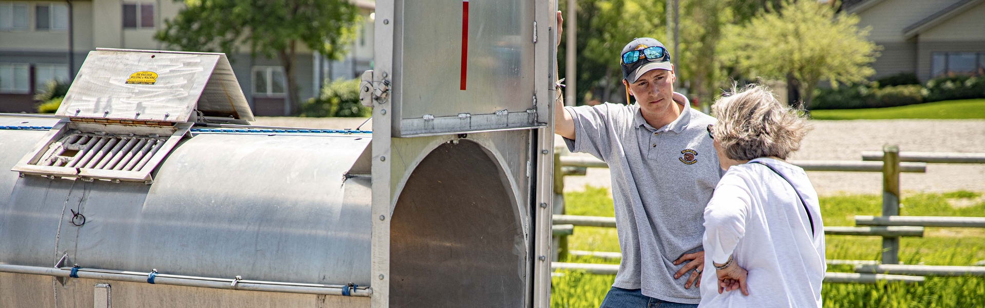 FWP Employee showing a resident a bear transportation trailer.