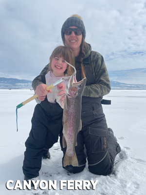 mom and daughter holding rainbow trout