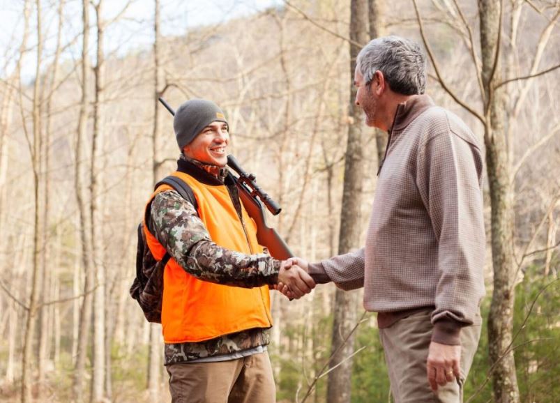 Hunter and landowner shaking hands