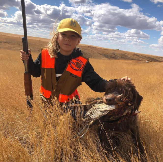 Youth hunter with pheasant