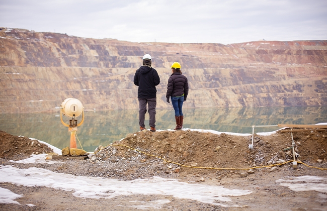 Scientists stand next to a searchlight at the Berkeley Pit to help identify birds at night.