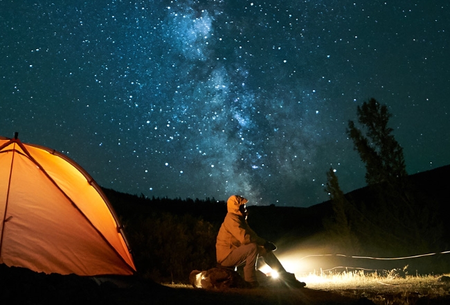 Camper under starry night
