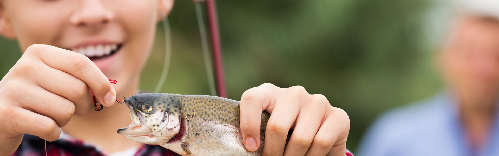 Kid with hooked fish