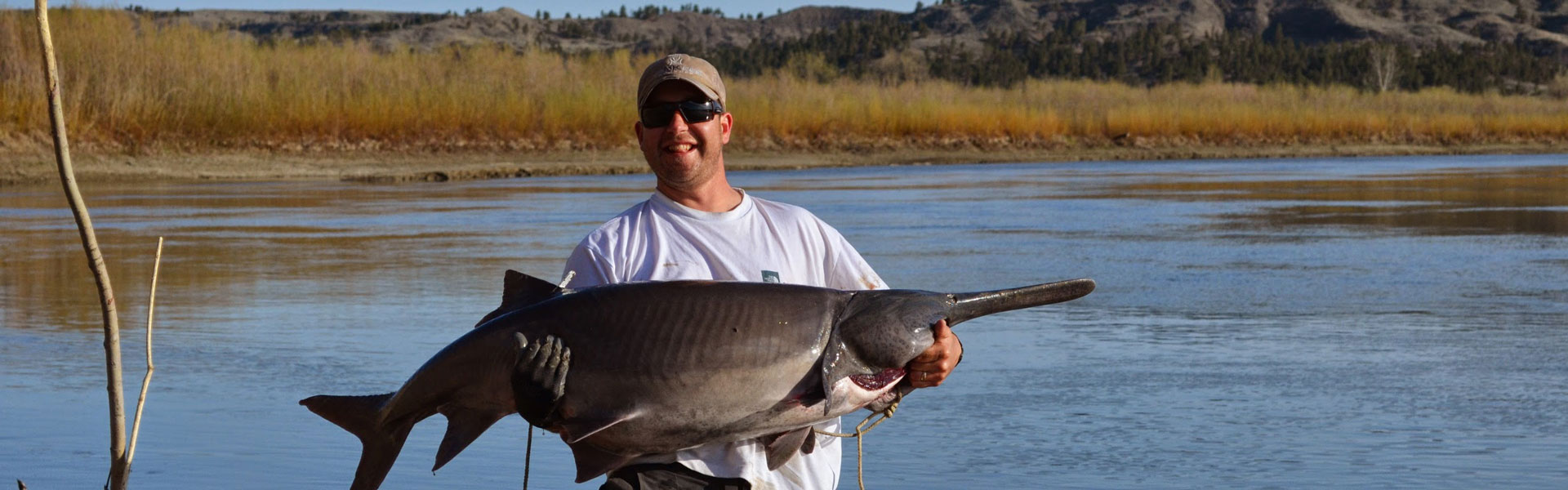 man holding paddlefish