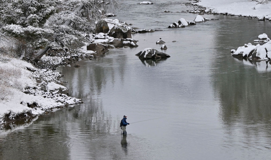 Photo of angler flyfishing in winter