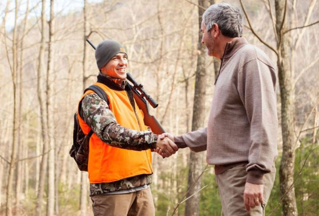 Hunter and landowner shaking hands